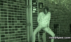 Blonde on heels pissing at a building entrance