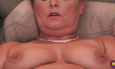 A mature woman named Talita, feeling amorous, is stimulating herself vaginally while being recorded.